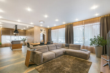 Luxurious interior of a country house with panoramic windows. Stylish furniture, exclusive room decor.