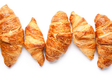 Many tasty croissants on white background