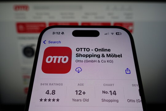 Kiel, SH, Germany March 27 2025: Otto app by Otto GmbH & Co KG in the App Store on smartphone screen with company website displayed in the background