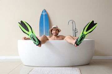 Male tourist with flippers in bathtub on vacation © Pixel-Shot