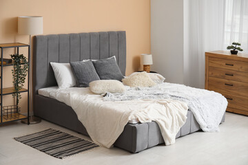Interior of stylish bedroom with big bed and lamps