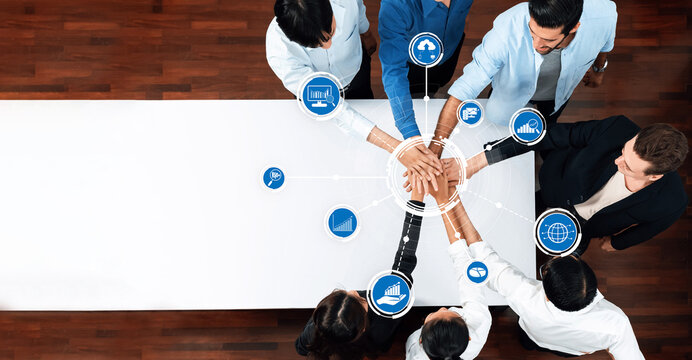 A diverse business team collaborates in a strategic planning session, focusing on digital analytics and innovative data visualization concepts to drive success. Amity