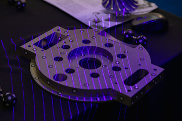 Purple laser lines scanning a mechanical component, enhancing precision in reverse engineering and...