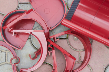 accessories for a roof gutter, plastic red fasteners and gutter caps, gutter bracket