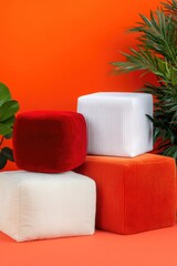 Colorful soft cubes arranged against vibrant orange background w