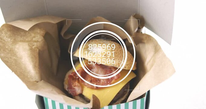 Burger in box with data processing animation overlaying nutritional information