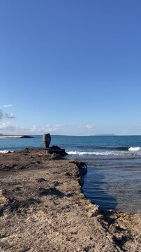 Greek Vase Pithos on the shore, , waves on Potamos beach in Malia Crete, Greece