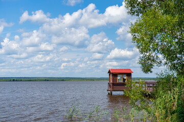 Gazebo on the lake shore on a summer day