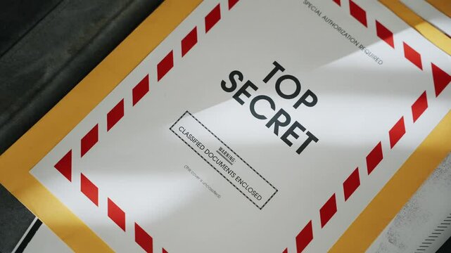 Briefcase being opened containing top secret folder with classified documents. Retro old looking manila envelope with red label coversheet. Government agency suitcase stealing sensitive files and info