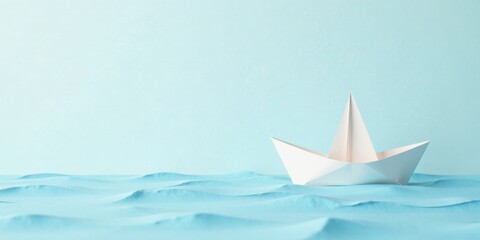 Obraz premium A solitary paper boat navigates a tranquil, textured sea, symbolizing hope, journey, and the simple elegance of handmade crafts.