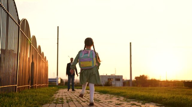 girl running from class, school building, schoolchild running, smile teeth, parent, children dream, child school backpack runs across school yard, man, daughter, happy girl runs into her father arms