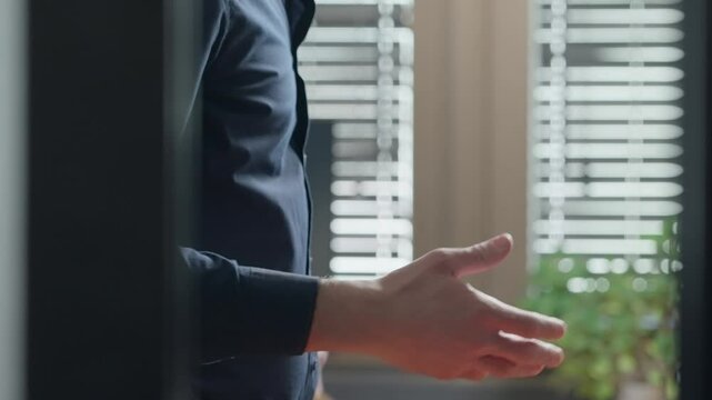 Two men exchange secret document files in yellow folder inside corporate office. Mysterious shady suspicious deal indoors. Passing government intelligence and confidential information and shake hands