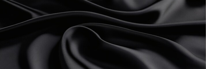 Obraz premium Elegant black satin fabric with soft waves, luxury texture for fashion designs
