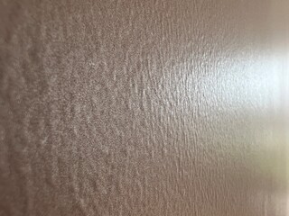 vintage wall reflecting the sunlight with sparkling pigment as backdrop with texture in rose and grey