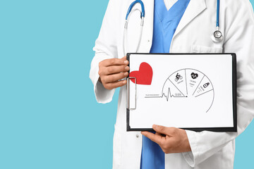 Young male doctor holding clipboard with pulse measurement diagram on blue background. World Health...