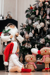 Christmas Tree with Gifts and Toys Decor for New Year at home. Santa figures, wreaths, and other holiday decorations. The vibrant display creates cheerful and traditional holiday atmosphere
