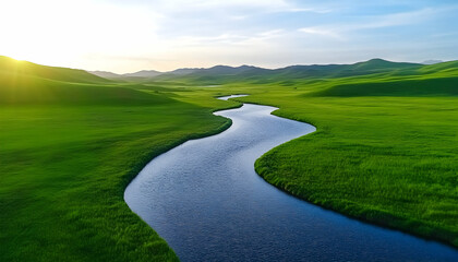 Naklejka premium Serpentine river meanders through lush green valley at sunset