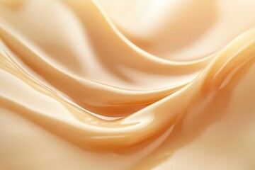 Smooth, creamy, light-brown liquid swirls elegantly, showcasing luxurious texture.