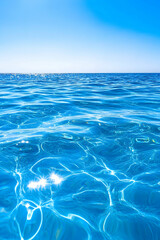 Serene ocean surface with clear blue water and bright sunlight