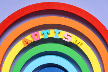 Obraz premium Rainbow with word AUTISM on lilac background