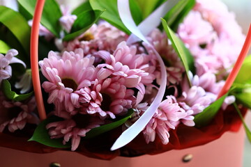 A bouquet of pink flowers surrounded by green leaves.