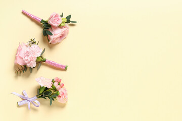 Set of beautiful boutonnieres on color background