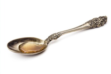 An ornate silver spoon holds a glistening pool of honey, a sweet and luxurious treat.
