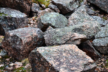 A natural rocky formation covered in green moss, ideal for outdoor and nature-themed designs.