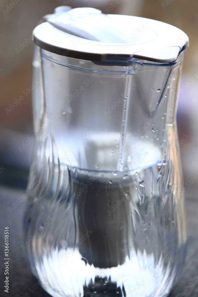 Poster a clear glass of water with ice cubes and a subtle reflection.