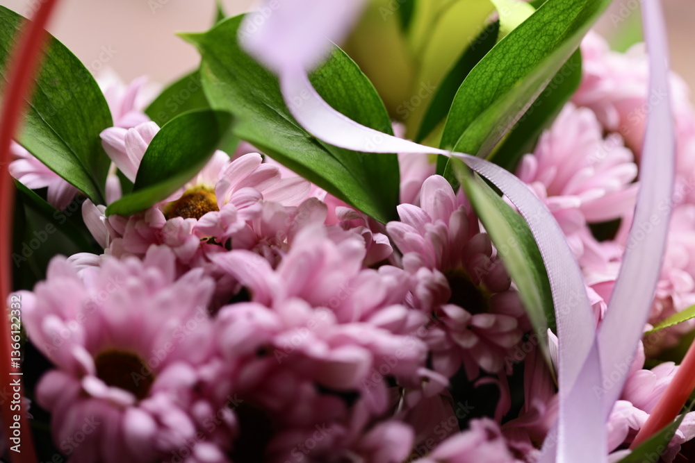 Poster a close-up view of a bouquet of colorful flowers arranged in a wicker basket.