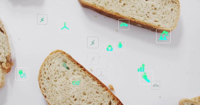 Eco-friendly icons overlaying on slices of bread against white background
