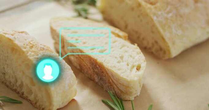 Sliced bread with digital chat icon animation over rosemary sprigs