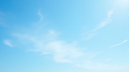 Clear blue sky with wispy white clouds. Bright and airy atmosphere