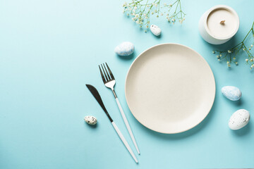 Easter table setting on blue.