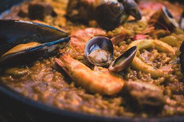 Spain, March 06, 2025: Detailed view of paella, a traditional Spanish dish made with rice, saffron, vegetables, meat and or seafood. It originates from the Valencian Community
