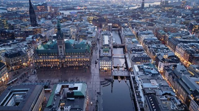 Hamburg, Germany: Aerial drone footage of the famous Hamburg Town hall, the St Nikolai Memorial church and the canal toward the Elbe river in the background in Germany. Shot with a forward motion