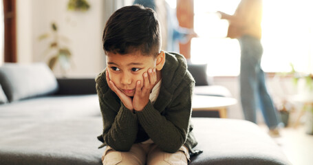 Fototapeta premium Anxiety, boy and couple fighting in living room of home for anger, argument or toxic relationship. Conflict, fear and family with child on sofa in apartment with parents shouting for frustration