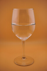 Colored water dropping into a wine glass filled with water.