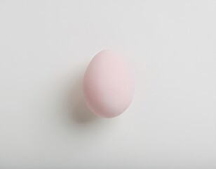 Fototapeta premium Minimalist pale pink egg on white background