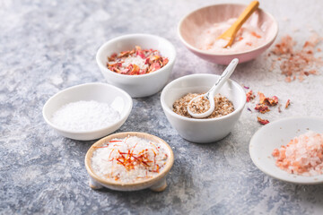 Assortment of different types of salt, sea, himalayan, saffron, with flower buds and lemon salt