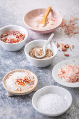 Assortment of different types of salt, sea, himalayan, saffron, with flower buds and lemon salt