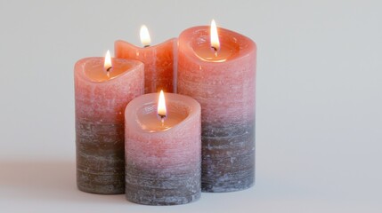 Lit wax candles create a serene atmosphere in an isolated setting with soft illumination