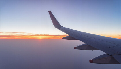 Airplane wing overlooking serene sunset, wanderlust inspiration