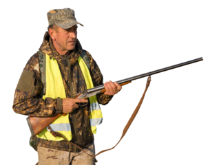 Hunter man in camouflage with a gun during the hunt in search of wild birds or game.