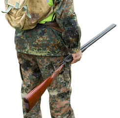 Hunter man in camouflage with a gun during the hunt in search of wild birds or game.