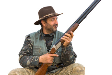 Hunter man in camouflage with a gun during the hunt in search of wild birds or game.