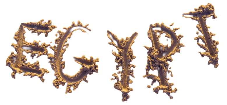 Handwritten word EGYPT on brown sand on the beach on the sunset.