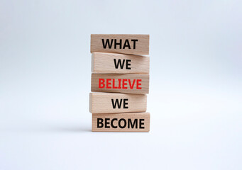 Naklejka premium What we Believe we Become symbol. Concept words What we Believe we Become on wooden blocks. Beautiful white background. Business concept. Copy space.