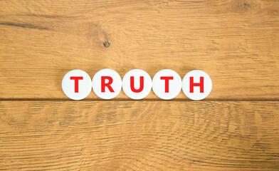 Truth symbol. Concept word Truth on beautiful white pills circles. Beautiful wooden table wooden...