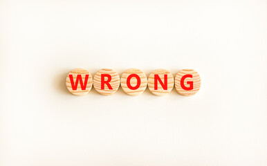 Wrong symbol. Concept word Wrong on beautiful wooden circles. Beautiful white table white...